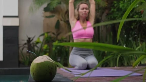 Woman doing stretching exercise at poolside Stock Footage 250979729