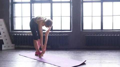 Woman doing stretching exercises doing her pre workout yoga stretching Video stock 135544580
