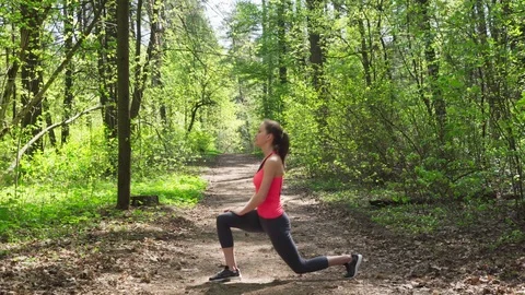 Woman doing stretching before run in forest Stock Footage 107282575