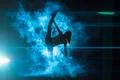 The woman doing vertical split in a smoke on the bright light background Photo