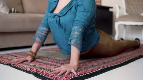 Woman doing yoga pose routine in colorful mat at home Stock Footage 168755344