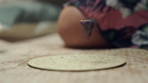 Woman Dowsing with Pendulum in Calm Esoteric Setting Video stock 324932072