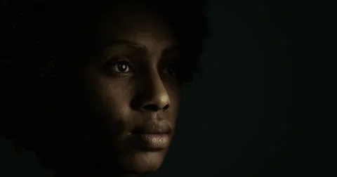 Woman in dramatic lighting looking thoughtfully into the distance Stock Illustration