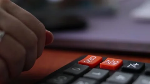 The woman dramatically presses the delete button on the calculator Stock Footage 156394187