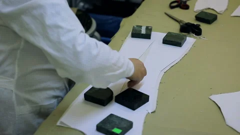 A woman is drawing a pattern. Worker in the sewing workshop Video stock 95396118