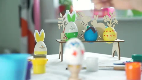 Woman Drawing Patterns on the Easter Egg Stock Footage 103932696