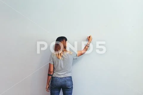 Woman Drawing On A Wall