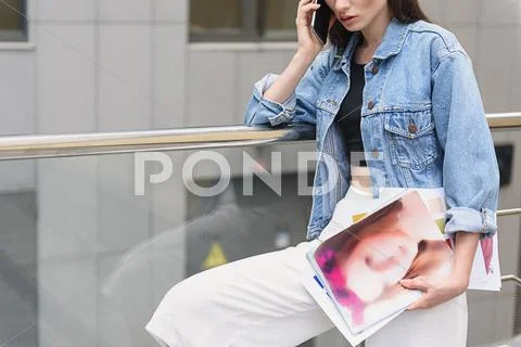 Woman with drawings standing outdoors Stock Photos