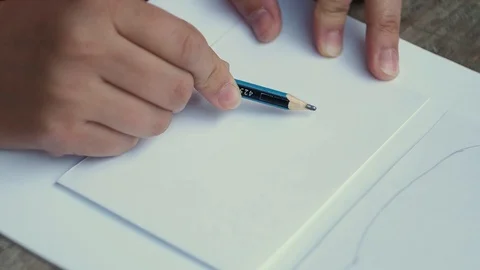 The woman draws a cloud on the sheet of paper. Stock Footage 102736010