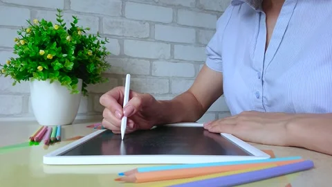 Woman draws a pattern on the graphic tablet, education online Stock Footage 201255975