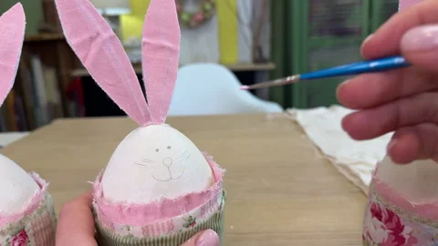 Woman draws a pencil face for Easter bunny, master class on making Easter bunny Stock Footage 305191990