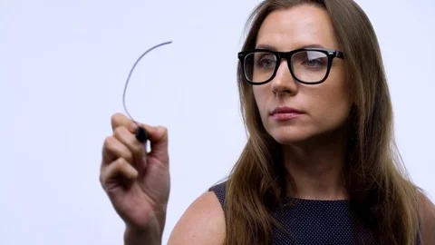 Woman draws various growth charts, calculating prospects for success in a modern Stock Footage