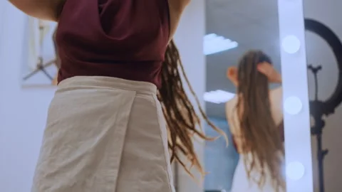 Woman with dreadlocks dancing in mirror reflection Видео 335933471
