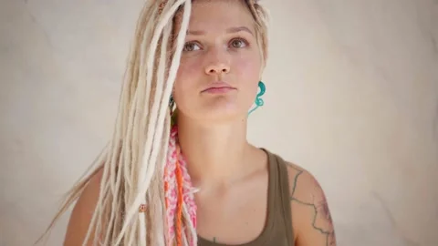 Woman with dreadlocks looking at camera Stock Footage 139299504