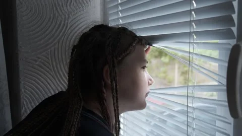 A woman with dreadlocks looking out a window Stock Footage 274066025