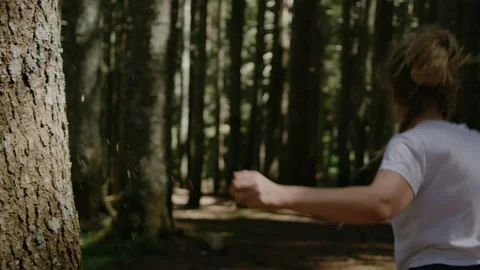 Woman with dreadlocks Touching large pine tree in forest and running into forest Stock Footage 151032681