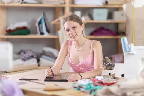 Woman dressmaker makes pattern using tablet Stock Photos
