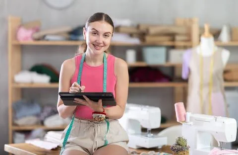 Woman dressmaker makes pattern using tablet Foto stock