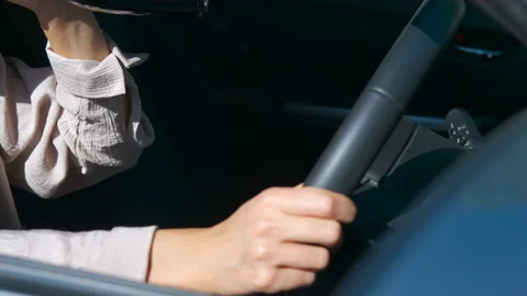 Woman drinking alcohol while driving a car Stock Footage 344176536