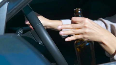 Woman drinking beer while driving a car. Stock Footage 330685053