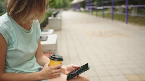 Woman drinking coffee and looking at phone Видео 65287985