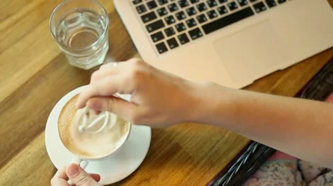 Woman drinking coffee and using digital tablet in the coffee shop Stock Footage 52878009
