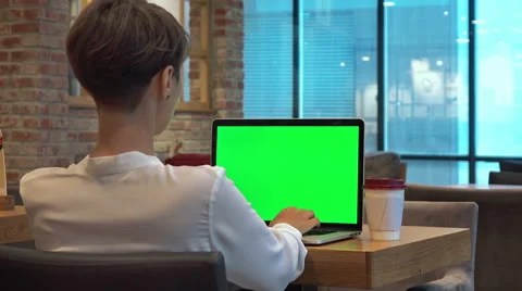 Woman drinking coffee and using of the laptop computer with green screen Stock Footage 67285798