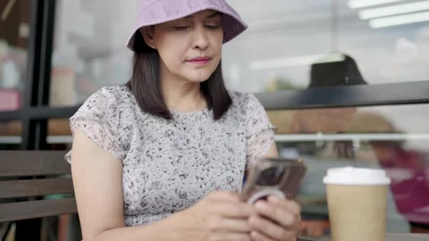 Woman drinking coffee and using smartphone in kitchen while getting ready for wo Stock Footage 252733386