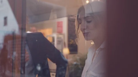 Woman drinking coffee in café through window Stock Footage 122575418