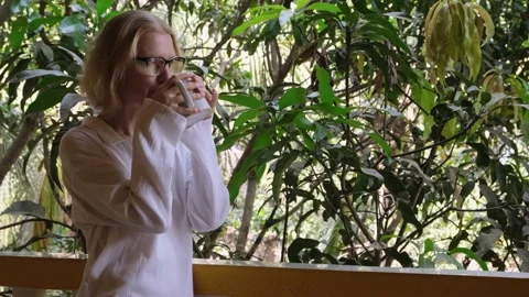 Woman drinking coffee or tea outdoor. Video stock 238914570