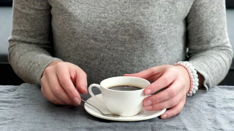 Woman drinking coffee at the table. selective focus. Stock Footage 147968276