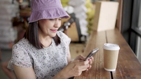 Woman drinking coffee using mobile phone Stock Footage 252732267