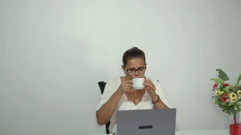 Woman Drinking A Cup Of Coffee While Using Laptop. Stock Footage 226557251