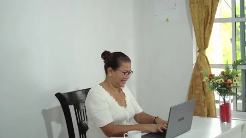 Woman Drinking A Cup Of Coffee While Using Laptop. Stock Footage 226557554