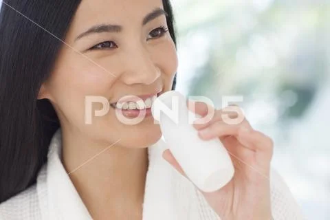 Woman drinking health drink Stock Photos