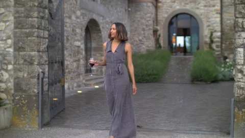 A woman drinking red wine while traveling at a luxury resort in Italy, Europe, s Stock Footage