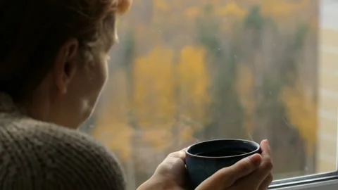 Woman drinking tea at the window Stock Footage 102849544
