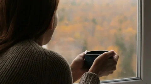 Woman drinking tea at the window Stock Footage 102849747