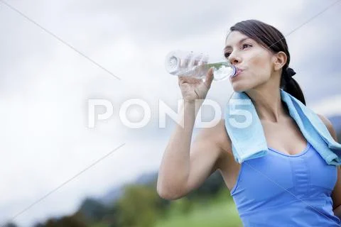 Woman drinking water after exercise Stock Photos