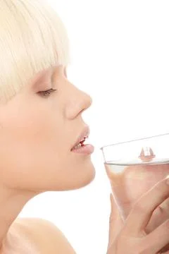 Woman drinking water Attractive caucasian woman drinking water from glass ... Stock Photos