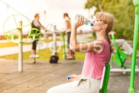Woman with drinking water taking break. Fitness. Stock Photos