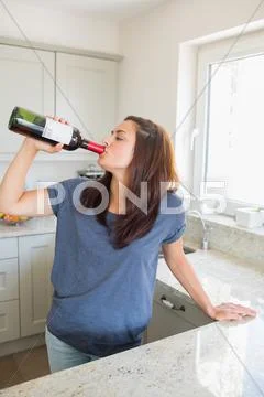 Woman drinking wine straight out of the bottle Stock Photos