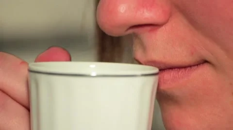 Woman drinks coffee from a cup Stock Footage 68908863