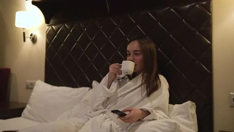 Woman drinks hot, invigorating black coffee from white mug early in the morning. Stock Footage 146474883