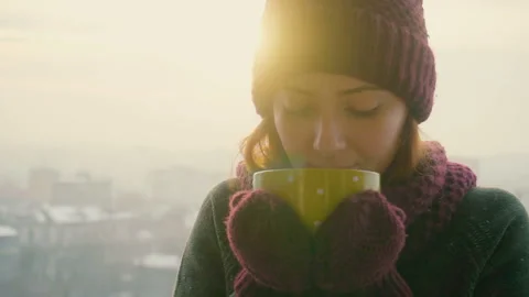 Woman Drinks Hot Tea or Coffee From yellow Cup on Winter Morning Stock Footage