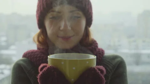 Woman Drinks Hot Tea or Coffee From yellow Cup on Winter Morning Stock Footage 86234591