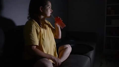 Woman drinks kombucha while watching a movie 動画素材 336482767