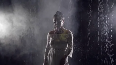 The woman is dripping water, the lady touches wet clothes with her hand Stock Footage