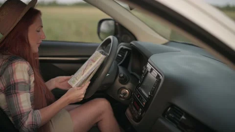 Woman driver looking at map. Stock Footage 159754416