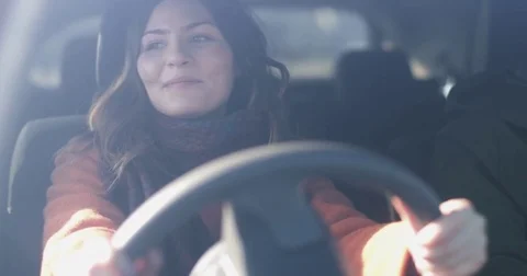 Woman driving car listening to music Stock Footage